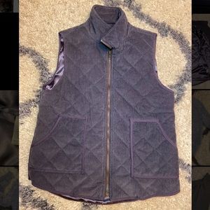 Dark purple vest with pockets and gold zipper